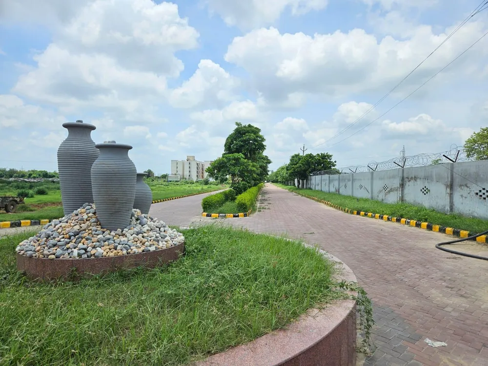Landscaped roundabout and paved internal road in Krish Season township, Alwar Bypass Road, Bhiwadi