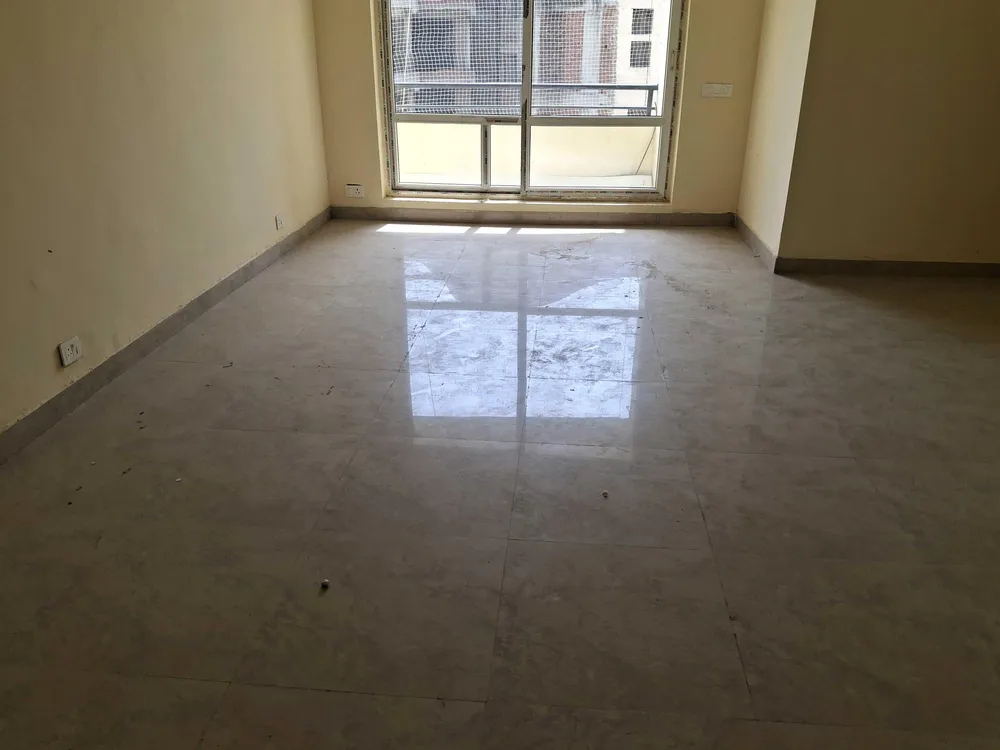 Living room with the balcony window, this 3 BHK flat at MVL Coral, Alwar Bypass Road, Bhiwadi