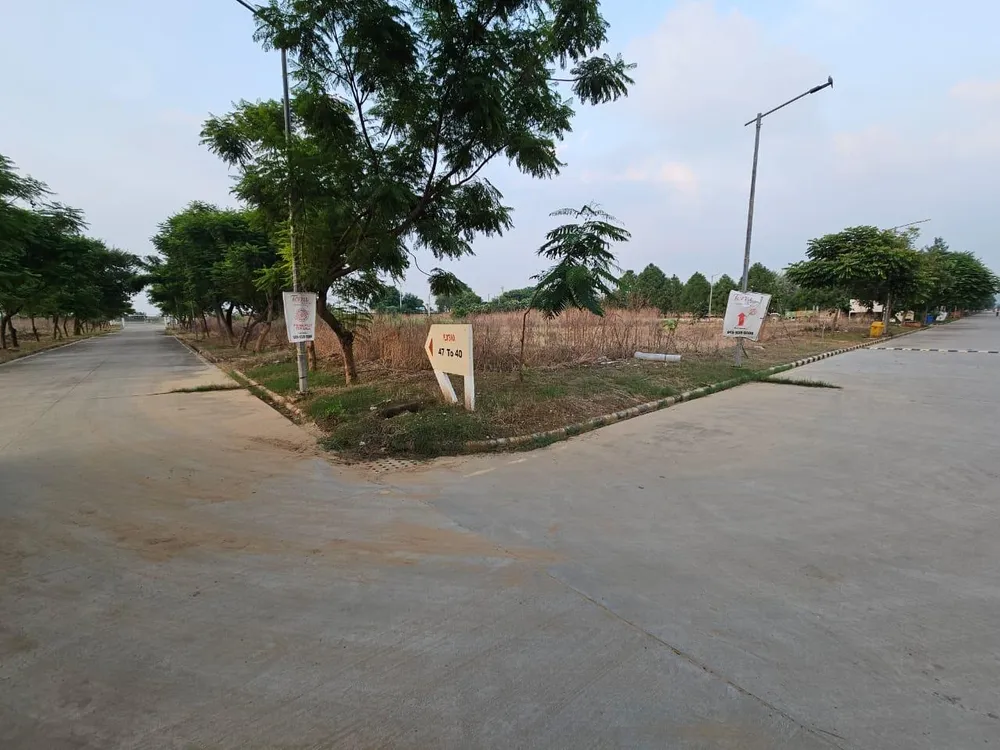 Concrete road junction beside unbuilt plots in Terra City, Alwar Bhiwadi Road, Bhiwadi
