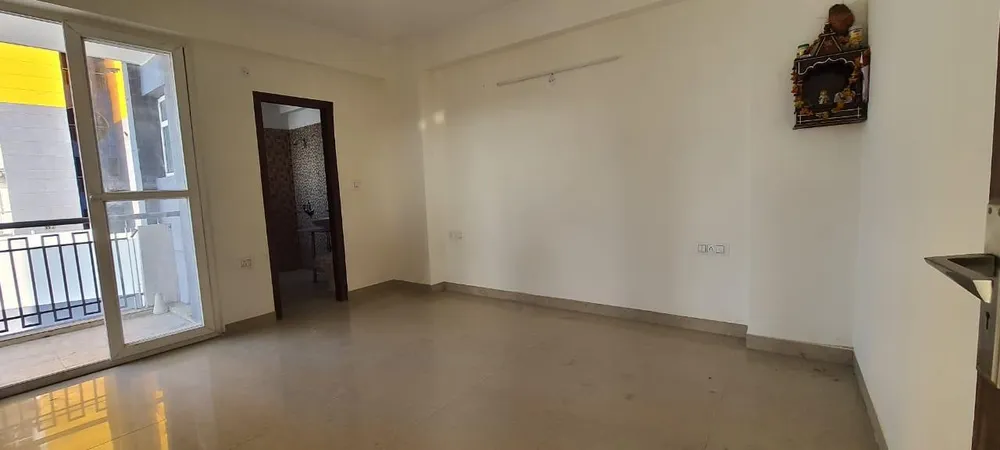 Empty hall with balcony door and bathroom doorway, this 3 BHK flat at The Cubix, Dharuhera