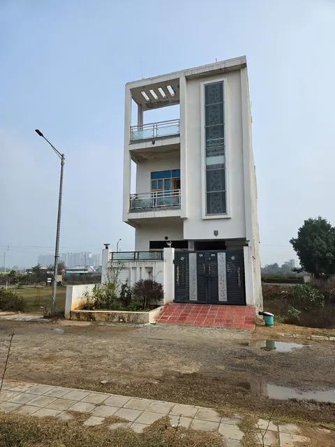 A completed house already built on a plot inside Dwarkadhis City — shown for reference, not this specific plot