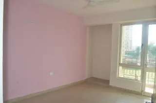 Bedroom with balcony view, this 2 BHK flat at Essentia, Bhiwadi