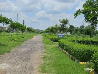 Plot number marker post and clipped hedge along an internal road in Krish Season, Bhiwadi