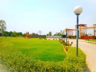 Open lawn inside Lifestyle City looking towards the entrance gate