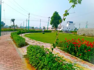 Landscaped park and paved walking path inside Lifestyle City, with built houses behind