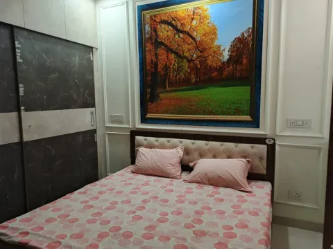 Double bedroom with a tufted headboard and marble-finish wardrobe in a 5 BHK villa, Madhuvan Residency, Bhiwadi