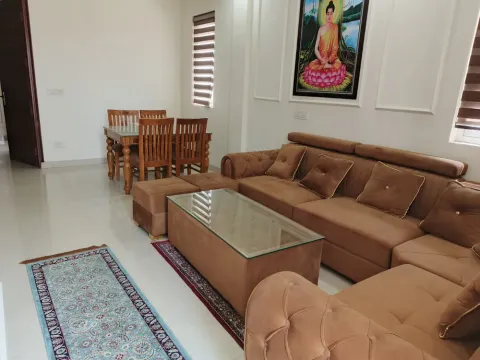 Sofa set and wooden dining table in the living area of a 5 BHK villa, Madhuvan Residency, Bhiwadi