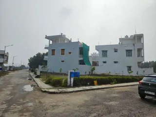 Completed houses on a kerbed internal street in MGH Anandam, Dharuhera