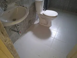 Second bathroom with grey wall tiles, this flat at MVL Coral, Bhiwadi