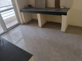 Kitchen with a stone counter and no cabinetry fitted, this flat at MVL Coral, Bhiwadi