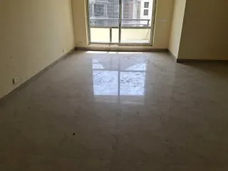Living room with the balcony window, this 3 BHK flat at MVL Coral, Alwar Bypass Road, Bhiwadi