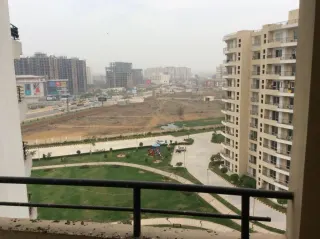 View from the balcony over the society lawn, the children's play area and the internal road, this 3 BHK flat at MVL Coral, Bhiwadi