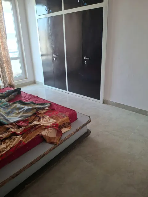 Bedroom with wardrobe, this 2 BHK flat at MVL Coral, Bhiwadi