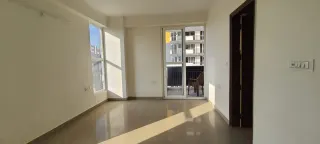 Room opening onto a balcony, this 3 BHK flat at The Cubix, Dharuhera