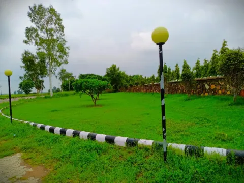 Grassed park with a stone boundary wall inside Lifestyle City township