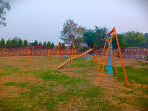 Children's play area with swings and a slide inside Lifestyle City township