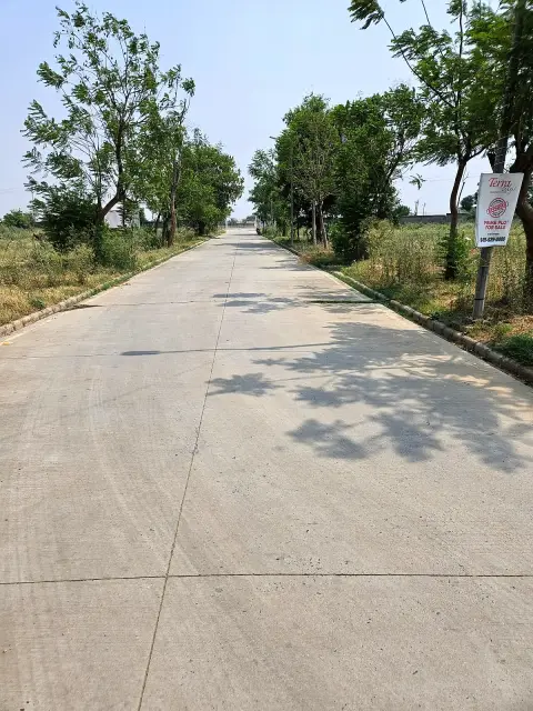 Constructed road and plot frontage in Terra City township near Tijara